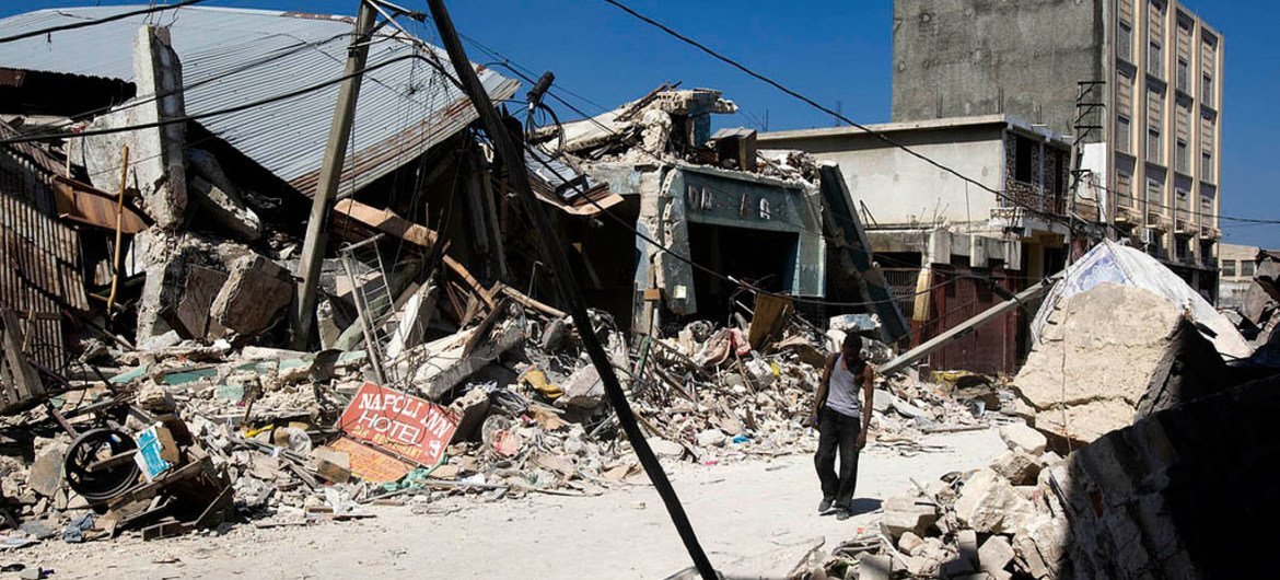 MINUSTAH/Marco Dormino A man walks through rubble of collapsed buildings in downtown Port au Prince, Haiti, which was rocked by a massive earthquake, on Tuesday 12 January 2010, devastating the city and leaving thousands dead.