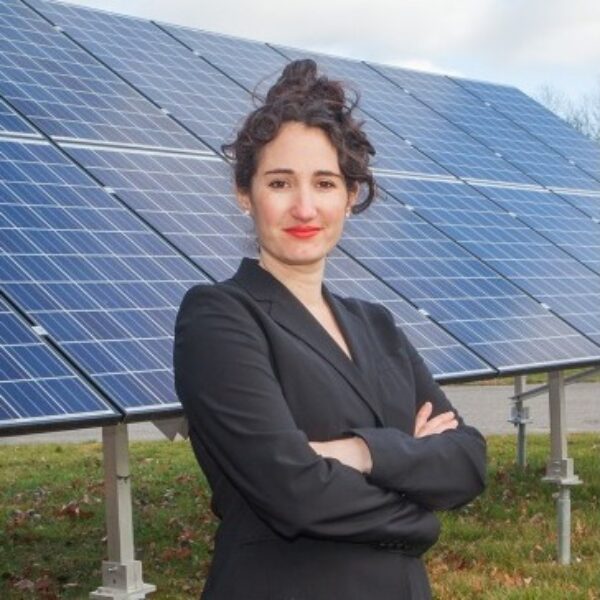 Dean Rushlow standing in front of solar panels.